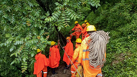 National Disaster Response Force (NDRF) personnel install ropes along an alternative pedestrian route after a landslide damaged the road at Sayanachatti, to facilitate the safe movement of pilgrims and local residents, in Uttarkashi, Uttarakhand, Saturday, July 11, 2026
