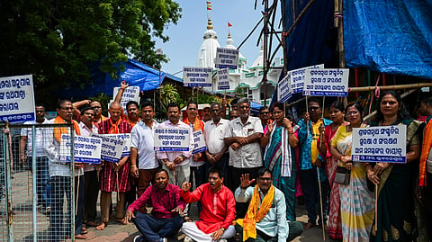 Sri Jagannath Sanskruti Prachar Sansthan members prtoest against ISKCON for organising Ratha Yatra across the world on unconventional dates, outside ISKCON Temple in Bhubaneswar on Sunday.