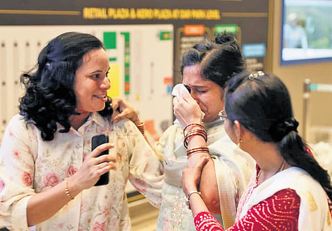 A tourist from Warangal breaks down after meeting her relatives, upon arrival from Vietnam, at the Rajiv Gandhi International Airport in Hyderabad on Sunday