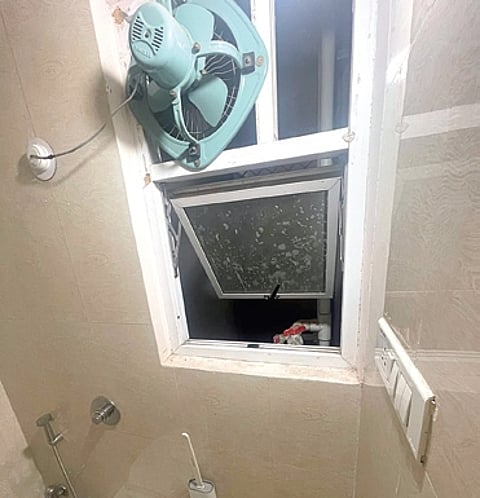 The bathroom window through which the teenager tried to exit