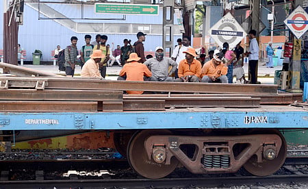 Southern Railway workers leave Tambaram railway station for track maintenance and engineering block works.