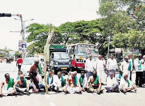 Farmers block the old Mysuru-Bengaluru highway protesting against the delay in releasing water for irrigation from the KRS reservoir in Mandya, on Monday