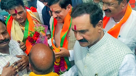BJP leader Narottam Mishra (R) and Madhya Pradesh Chief Minister Mohan Yadav arrive for the nomination filing of BJP candidate from Datia, Ashutosh Tiwari, in Datia on Monday, July 13.
