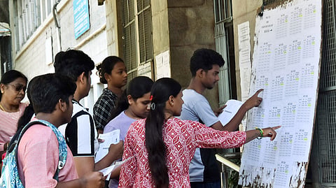 In this photo from June 21, 2026, candidates check their roll numbers in the list before appearing for the NEET-UG 2026 re-examination in Bengaluru.
