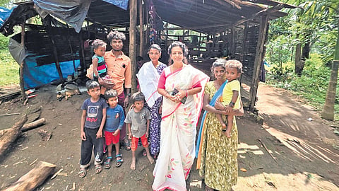 M S Sunil with the members of the Malampandaram tribe for whom 20 houses are being built at Manjathode, Laha in Pathanamthitta.