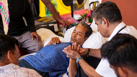 Climate activist Sonam Wangchuk being attended by medical professionals during a protest by Cockroach Janata Party (CJP) demanding Union Education Minister Dharmendra Pradhan's resignation over alleged irregularities in the NEET examination, at Jantar Mantar, in New Delhi, on Tuesday, July 14, 2026.