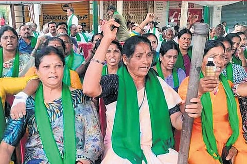 Women farmers protest with pestles at Byramangala Cross near Bidadi on Tuesday