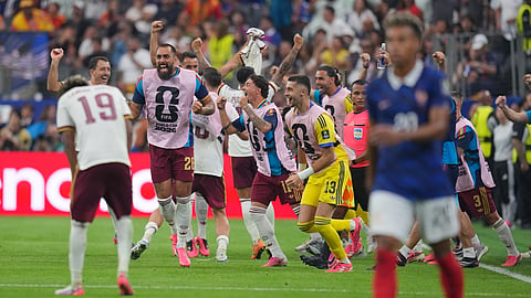 Spain's players celebrate after defeating France in the first semi-final of the 2026 FIFA World Cup match in Arlington, Texas, near Dallas, on Tuesday, July 14, 2026.