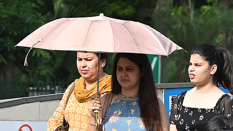 People seen out during a hot day at Connaught Place , on June 13, 2026 in New Delhi.