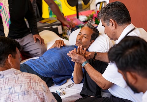 Climate activist Sonam Wangchuk being attended by medical professionals during a protest by Cockroach Janata Party (CJP) demanding Union Education Minister Dharmendra Pradhan's resignation over alleged irregularities in the NEET examination, at Jantar Mantar, in New Delhi, Tuesday, July 14, 2026.