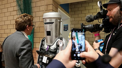 Independent candidate Count Binface speaks to a journalist as he arrives for the vote count in Britain's general election at the Richmond and Northallerton count centre in Northallerton, England, Friday, July 5, 2024.