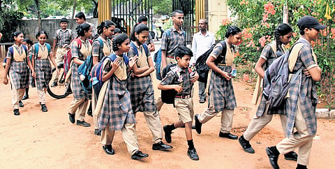 School children entering school after reopening in Visakhapatnam on Monday.