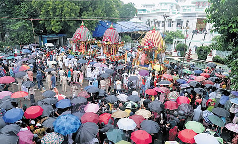 Devotees, braving heavy rains, throng the ISKCON temple to participate in chariot pulling for Rath Yatra, in Bhubaneswar on Thursday