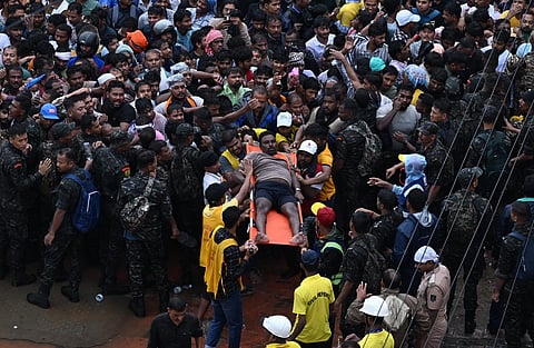 An injured devotee being carried on a stretcher as lakhs of people thronged Bada Danda to witness the annual Ratha Yatra in Puri on Thursday.