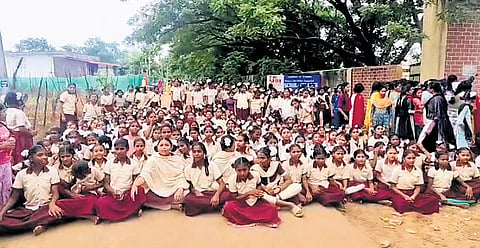 Students stage a protest outside the school campus at Gandhi Nagar in Kothaguda mandal headquarters of Mahbubabad district on Thursday