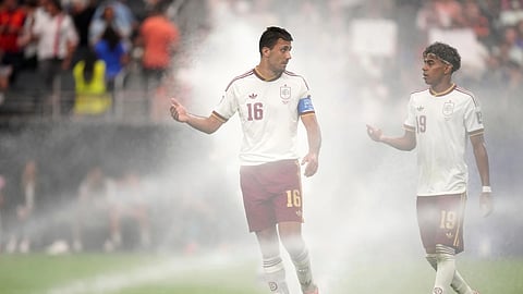 Spain's Rodri (16) and Lamine Yamal (19) chat as they walk among sprinklers during the World Cup semifinal soccer match between France and Spain in Arlington, Texas, Tuesday, July 14, 2026.