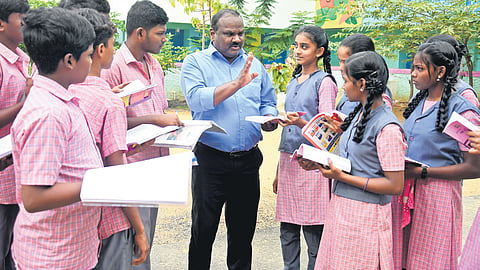 Shakthi Sivam interacting with the students of the Government High School in Perumbakkam, where his hands-on approach has helped increase the school’s pass rate in Class 10 from 41% to 100% in last four years
