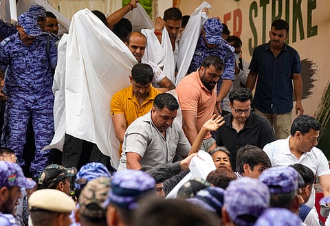 Activist Sonam Wangchuk, who has been on an indefinite hunger strike for 21 days, waves as he is shifted to a hospital from Jantar Mantar, in New Delhi, Saturday, July 18, 2026.