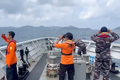 Rescuers scan the horizon as they search for victims after a passenger boat sank in the waters near Selayar Island in South Sulawesi, Indonesia.