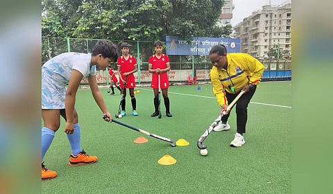 Karuna Purty train young hockey players.