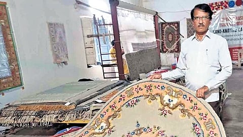 Abdul Nayeem of Hafeez Carpets works on a handmade carpet and shares his experience at Tangellamudi.