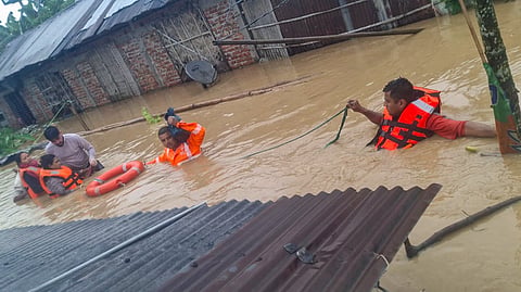 NDRF officials conduct a rescue operation in a flood-affected area, in Assam.