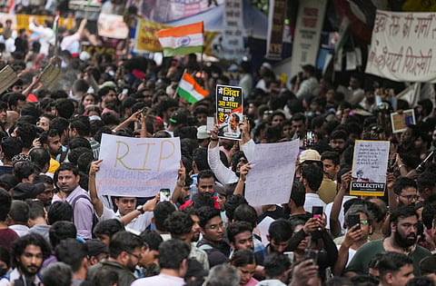 Cockroach Janata Party (CJP) supporters hold posters during a protest demanding Union Education Minister Dharmendra Pradhans resignation over alleged irregularities in the NEET examination, at the Jantar Mantar in New Delhi, Sunday, July 19, 2026
