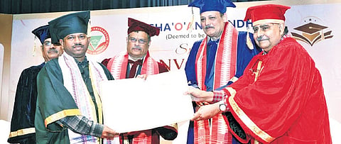 CJ Harish Tandon conferring PhD degree on a student. Justice Krishna Shripad Dixit, SOA chancellor Prof Amit Banerjee and V-C Prof Pradipta Kumar Nanda are present.