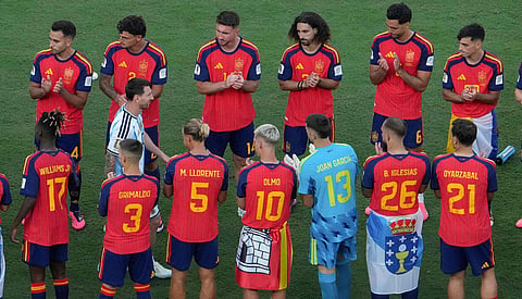 Lionel Messi walks past Spain's players during the final ceremony