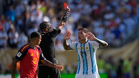 Referee Slavko Vincic, of Slovenia, shows a red card to Argentina's Enzo Fernandez (24) during the World Cup final soccer match between Spain and Argentina in East Rutherford, N.J., near New York, Sunday, July 19, 2026.