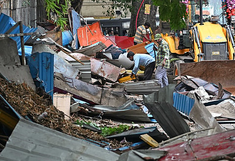 Kannada activists and others attack GBA officials and workers who came to evacuate the footpath at Shivajinagar in Bengaluru on Tuesday, where police arrested a few and later workers cleared with police protection.