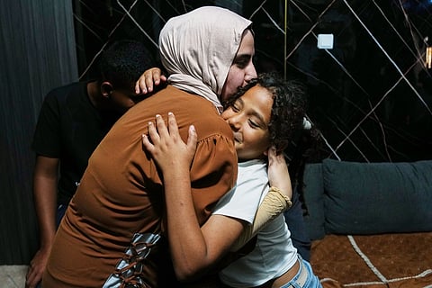 Mais Al-Gharam hugs her 8-year-old sister Arjwan, who was granted an Israeli passport, in her home in Nazareth, Israel, Wednesday, July 8, 2026, after Arjwan's arrival from the Gaza Strip