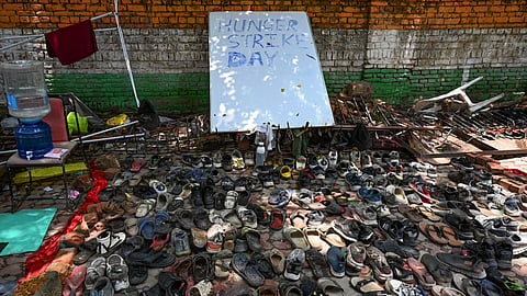 Footwear collected after the July 20 'Chalo Sansad' protest is displayed at Jantar Mantar as a symbol of the police crackdown during the demonstration over the alleged NEET examination irregularities in New Delhi, Wednesday, July 22, 2026.