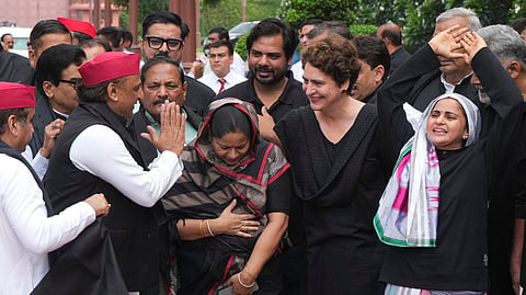 Congress MP Priyanka Gandhi Vadra, Samajwadi Party (SP) MP Akhilesh Yadav and other opposition leaders greet one another as they wear black clothes in protest to express solidarity with students protesting against the NEET paper leak issue, during the Monsoon session of Parliament, in New Delhi, Wednesday, July 22, 2026.