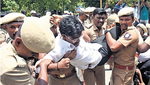 Police detaining a student staging protest near Rajarathinam Stadium in Egmore, Chennai, on Wednesday.
