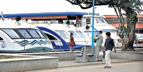People walking near the KSINC boat jetty at Marine Drive