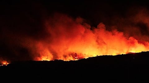 A blaze that raced through wooded hills in another part of southern France, forcing hundreds from their homes and devouring an area twice the size of London's Heathrow airport, was being contained earlier Wednesday, officials said.