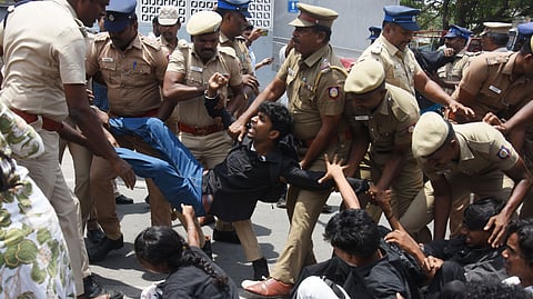Police detaining a student staging protest near Rajarathinam Stadium in Egmore, Chennai, on Wednesday.