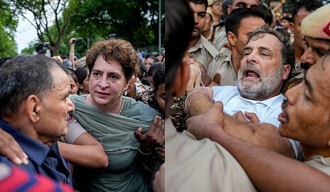 Security personnel detain Congress MPs Priyanka Gandhi Vadra and Rahul Gandhi during a sit-in protest near the Prime Minister's residence over alleged irregularities in the NEET examination, in New Delhi, Tuesday, July 21, 2026.