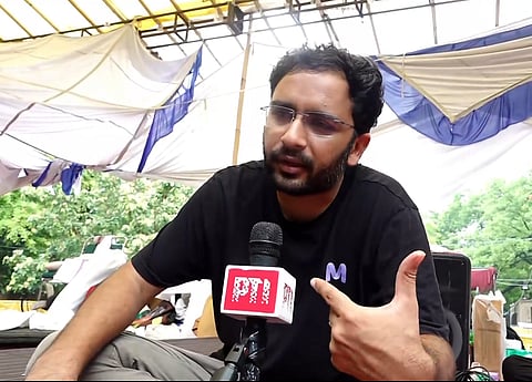 Cockroach Janta Party (CJP) Spokesperson Ashutosh Ranka speaks to PTI amid the ongoing CJP protest over the alleged NEET paper leak, at Jantar Mantar in New Delhi.