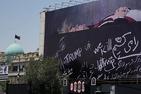 A billboard depicting U.S. President Donald Trump lying on what appears to be a coffin and bearing anti-Trump messages, including the phrase "We Kill Trump," is seen at Islamic Revolution Square in downtown Tehran, Iran, Wednesday, July 15, 2026.