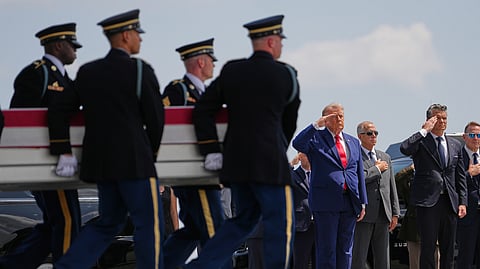 President Donald Trump and Secretary of Defense Pete Hegseth, salute as a U.S. Army carry team moves a transfer case containing the remains of Pvt. Isabella Gonzales of Carrollton, Texas, Wednesday, July 22, 2026, at Dover Air Force Base, Del.