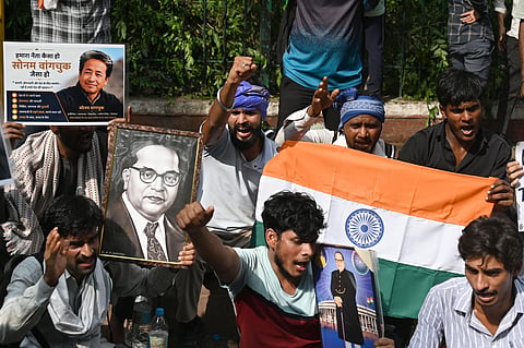 Protesters in large numbers continue their protest at Jantar Mantar in support of the Cockroach Janata Party (CJP), demanding the resignation of Union Education Minister Dharmendra Pradhan over alleged examination irregularities and NEET paper leak, in New Delhi on Thursday.
