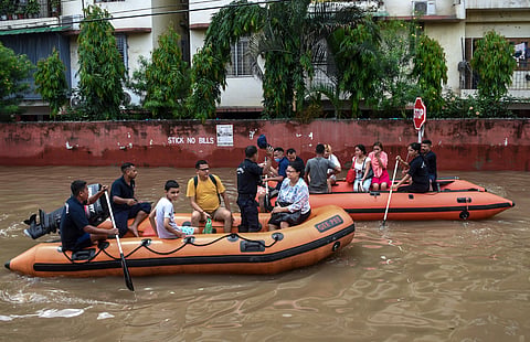 Guwahati: SDRF personnel rescue people from a water logged area following rainfall, at Rukmini Gaon, in Guwahati, Friday, July 24, 2026.