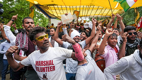 Cockroach Janta Party (CJP) supporters celebrate after Union Education Minister Dharmendra Pradhan resigned and took responsibility for the NEET paper leak at Jantar Mantar in New Delhi, Saturday, July 25, 2026.
