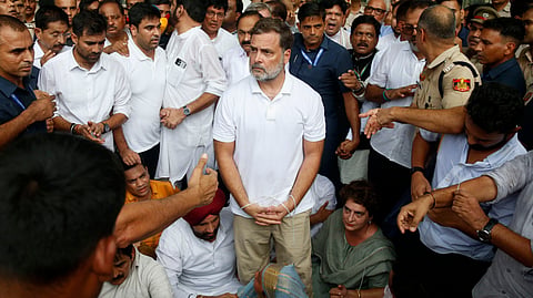 LoP leader Rahul Gandhi, center, with his hands tied, participates in a sit-in protest with his sister and lawmaker Priyanka Gandhi Vadra, center right, outside the residence of Prime Minister Narendra Modi, Tuesday, July 21, 2026.