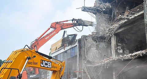Bulldozers demolish a building in Lucknow that housed the coaching centre where a fire broke out on June 22.