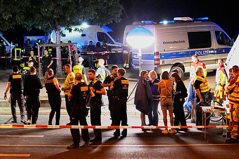 Emergency personnel and police gather in Berlin, early Sunday, July 26, 2026, following the cancellation of Christopher Street Day festivities.