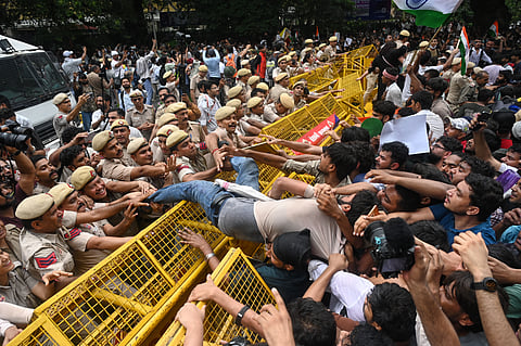 Supporters of the Cockroach Janta Party scuffle with police as they attempt to march toward the Parliament, demanding the resignation of the education minister, in New Delhi, Monday, July 20, 2026.