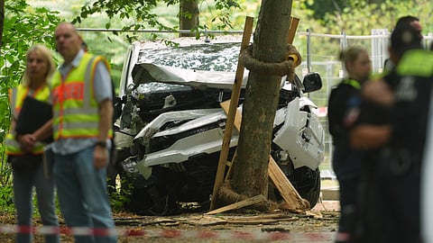 olice officers stand near a vehicle crashed into a tree after driving into a crowd near Berlin's annual Pride event, in Berlin, Germany, Sunday, July 26, 2026.